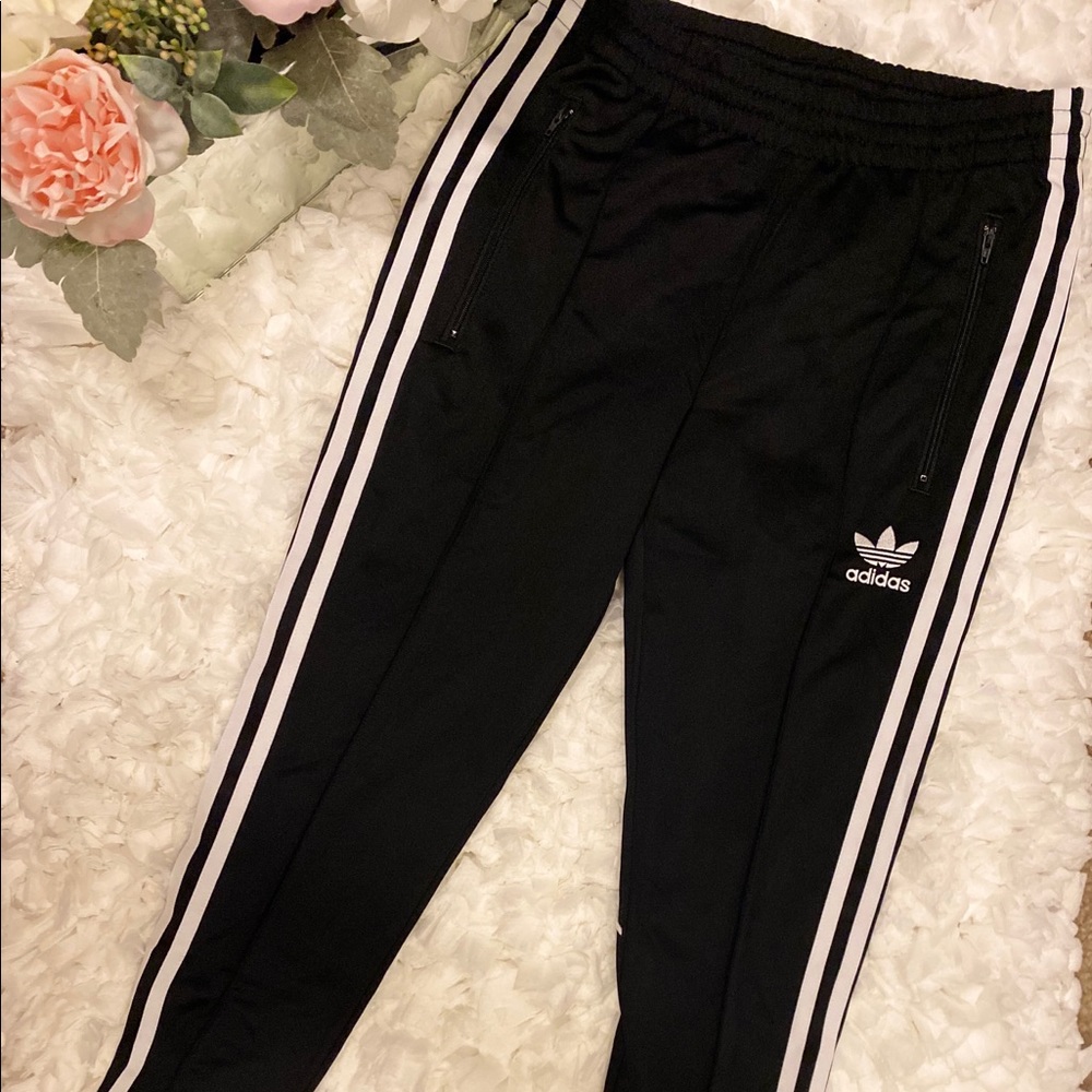 Adidas joggers with zipper on the sides.
